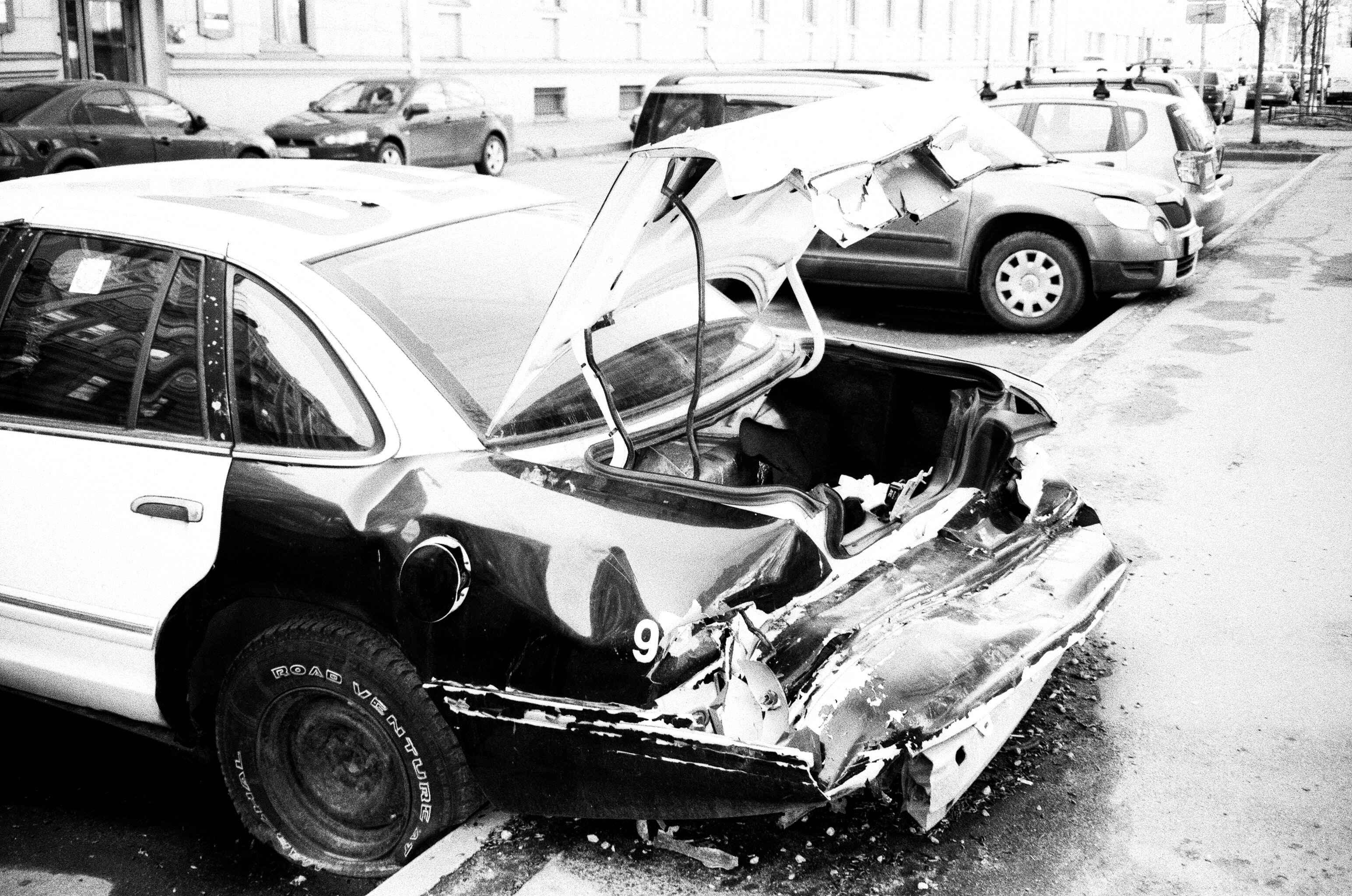 Featured: How to Handle a Hit and Run Accident - Smashed vehicle in parking lot