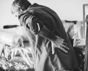 Featured image; Male adult holding lower back after an auto accident-
