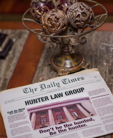 Hunter Law - About us - newspaper with bold headlines; Hunter Law Group