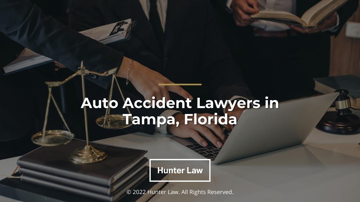 Featured: Legal team working together at desk at laptop- Auto Accident lawyers in Tampa, Florida