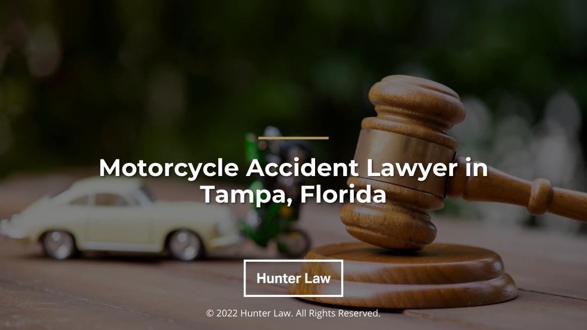 Featured: Scene of motorcycle accident, judges gavel in foreground- Motorcycle Accident Lawyer in Tampa, Florida