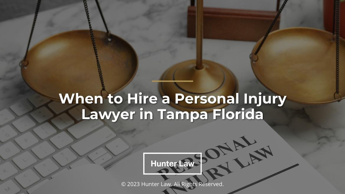 Featured: Justice scales and personal injury law document on desk- When to hire a personal injury lawyer in Tampa, FL