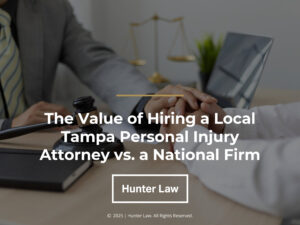 Attorney comforting a client at desk with balance scale and documents.