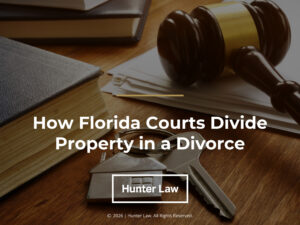 Judges gavel, law book, papers, keys on desk. Article title. How Florida courts Divide Property in a Divorce.