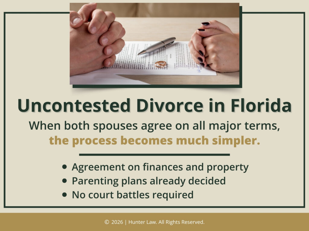 Two people with folded hands sit at desk ready to sign divorce documents. Uncontested divorce process is much simpler with spouses in agreement.