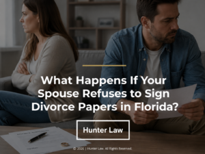 Frustrated couple sitting apart on a sofa with man reviewing divorce papers. Article title.